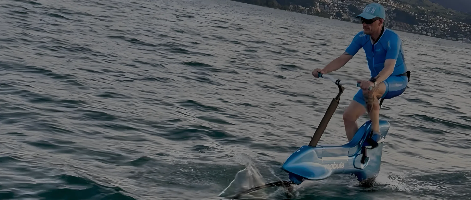 Cyrille C. Catel riding the Mobula bike foil across Lake Zurich, Switzerland, in July 2026.